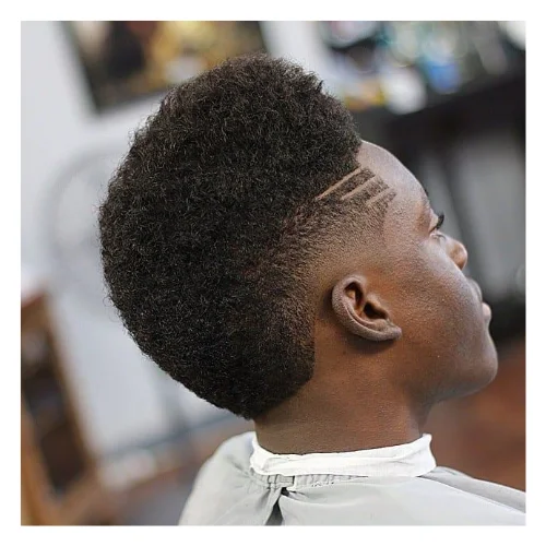 Low taper fade black burst haircut with textured black hair on top and clean burst fade around the ears for a sharp modern style