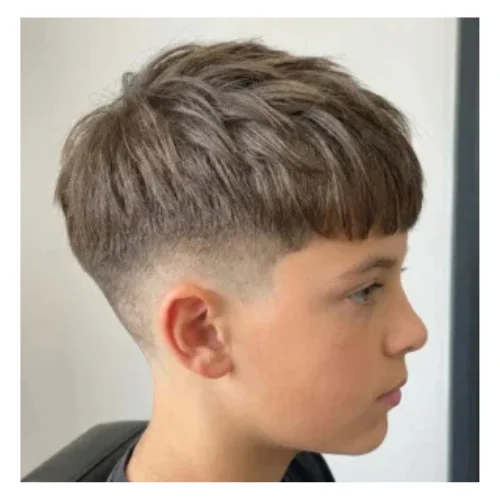 Young man with straight hair styled on top and a clean low taper fade on the sides.
Smooth fade around ears and neckline creates a sharp and modern everyday look.
